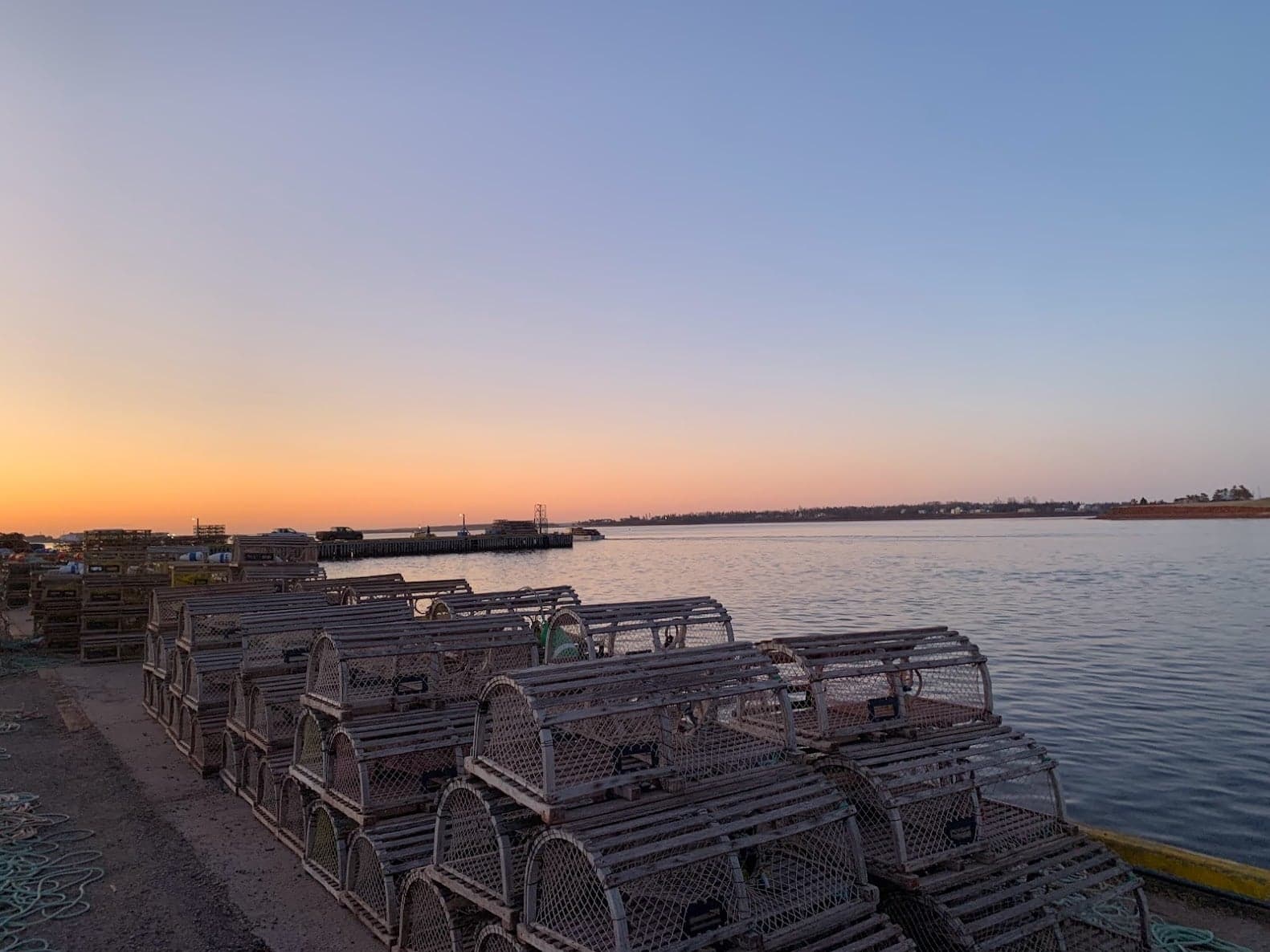 Lobster traps stacked beside North Rustico Harbour at sunrise